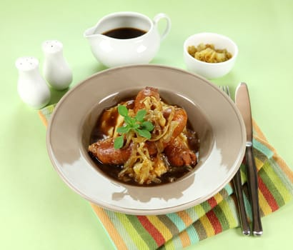 The classic English meal of bangers and mash with gravy ready to serve.