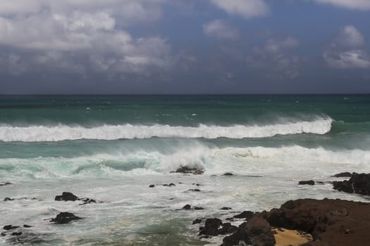 Pacific wave crashing over the Maui shore