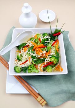 Delicious Asian noodle vegetarian soup with spoon ready to serve.