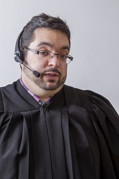 Preacher with headset microphone, in the middle of a speach, against white background