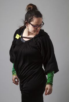 Woman wearing a black dress with green sleeves