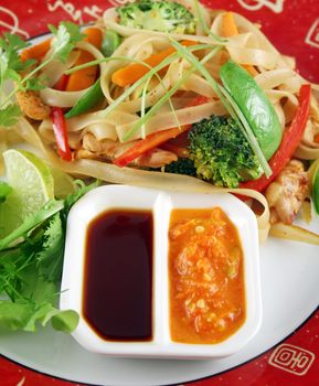 Chicken and rice noodle stirfry with soy and sambal olek sauces.