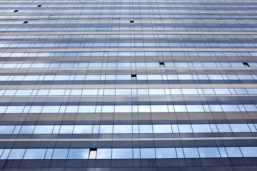 modern facade with open windows reflecting sky 