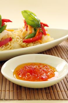 Sweet chilli sauce with chicken on crispy noodles.