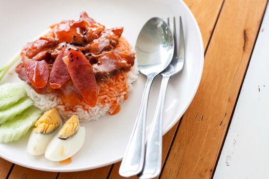 serving of rice with roasted pork on top