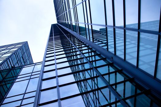 modern building of glass and steel reflecting blue sky