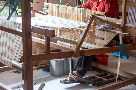 Woman working at the loom silk of thailand