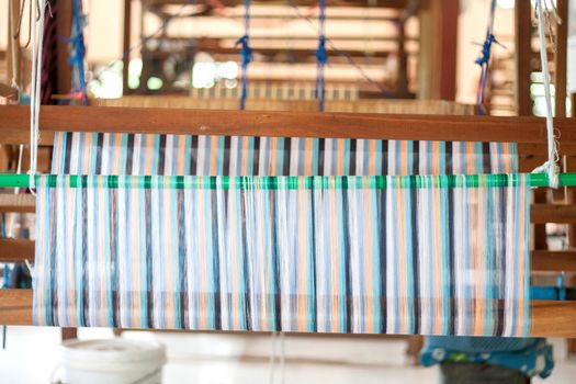 Silk weaving on a hand loom in thailand