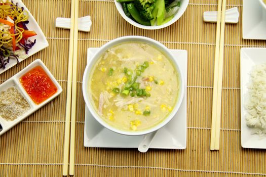 Delicious chicken and corn soup with asian vegetables and noodles.