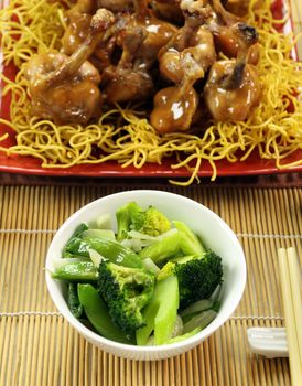 Asian green vegetables with mini chicken drumsticks.