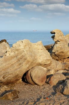 rocks on beach and ship