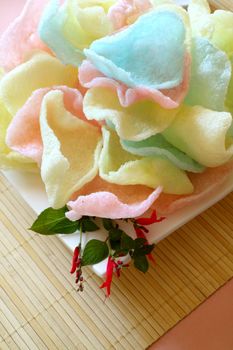 Delicious crispy Asian prawn crackers with spearmint leaves ready to serve.