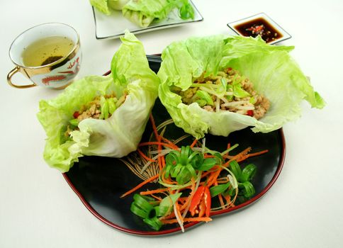 Delicious San Choy Bow with minced chicken and Chinese vegetables wrapped in fresh lettuce leaves.