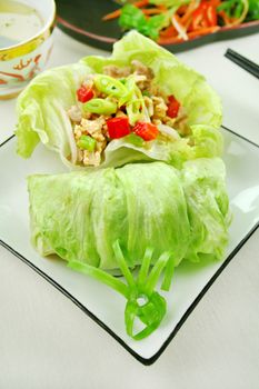 Delicious San Choy Bow with minced chicken and Chinese vegetables wrapped in fresh lettuce leaves.