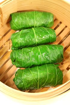 Asian chicken cabbage rolls in a bamboo steamer. 