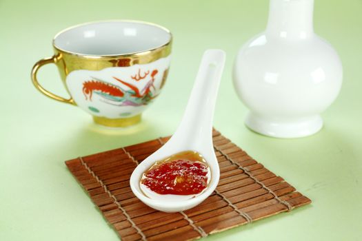 Sweet chilli sauce in a spoon ready to serve.