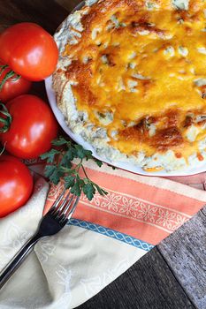 Freshly baked tomato pie with tomatoes on the vine.