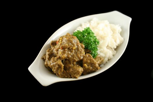 Beef vindaloo and rice ready to serve.