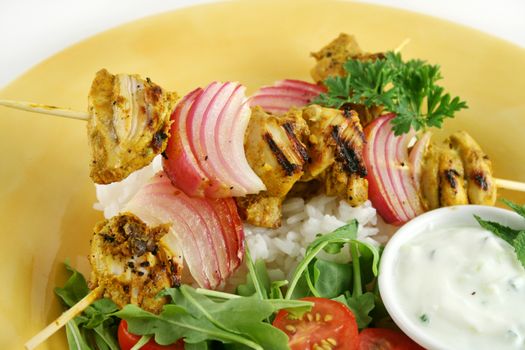 Chicken tandoori skewers with minted yogurt and a rocket salad.