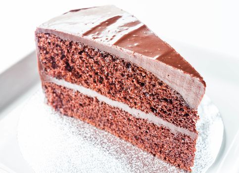 Piece of chocolate chiffon cake on white plate