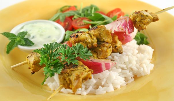 Chicken tandoori skewers with minted yogurt and a rocket salad.