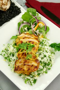 Delicious chicken tikka on a bed of lemon coriander rice with salad.