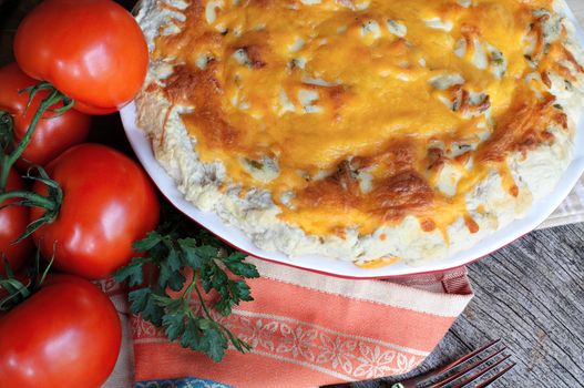 Freshly baked tomato pie with tomatoes on the vine.