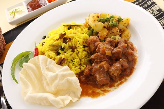 Delicious and spicy Indian beef curry served with pappadums.