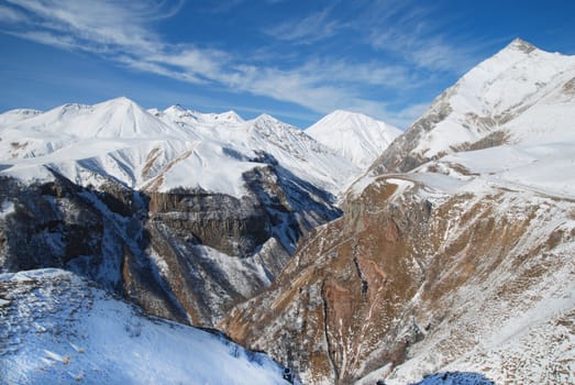 Big winter mountains and the blue sky