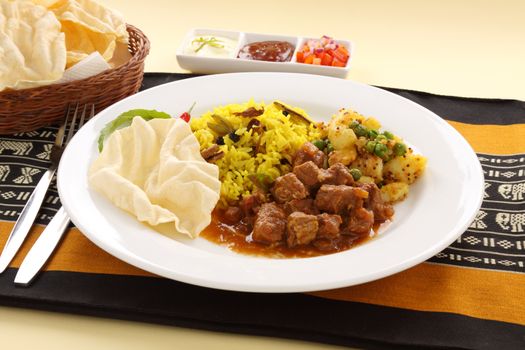 Delicious and spicy Indian beef curry served with pappadums.