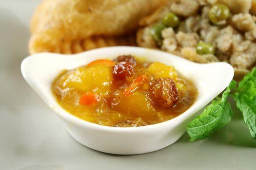 Indian vegetarian samosa with mango chutney.