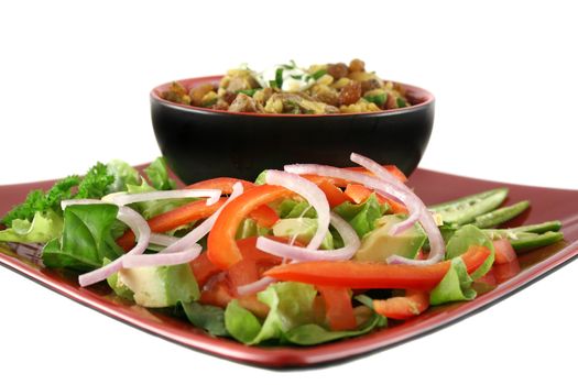 Indian lamb biryani with sultanas and yoghurt and a side salad.