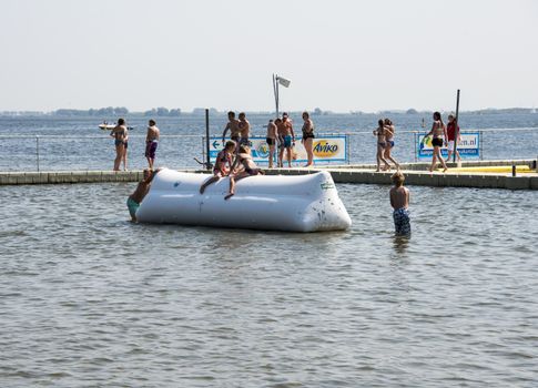 HELLEVOETSLUIS,HOLLAND - JULY 08:Unidentified children having pun in the aqua splash park ,on July 08,2013 in Hellevoetsluisk, Holland.This water park is the only open water park in Holland