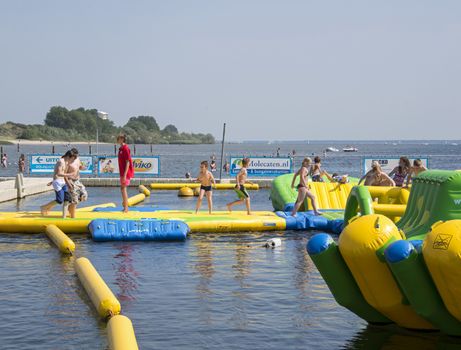 HELLEVOETSLUIS,HOLLAND - JULY 08:Unidentified children having pun in the aqua splash park ,on July 08,2013 in Hellevoetsluisk, Holland.This water park is the only open water park in Holland