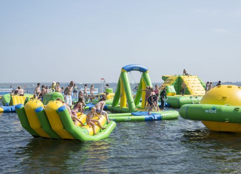 HELLEVOETSLUIS,HOLLAND - JULY 08:Unidentified children having pun in the aqua splash park ,on July 08,2013 in Hellevoetsluisk, Holland.This water park is the only open water park in Holland