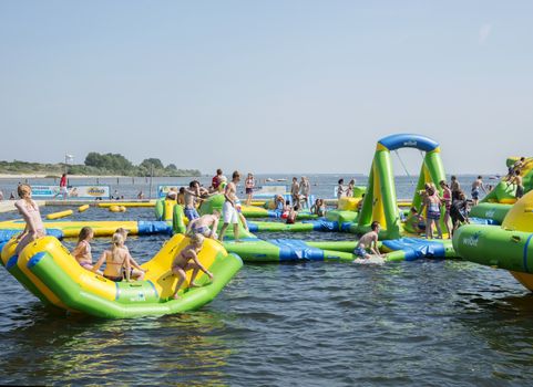 HELLEVOETSLUIS,HOLLAND - JULY 08:Unidentified children having pun in the aqua splash park ,on July 08,2013 in Hellevoetsluisk, Holland.This water park is the only open water park in Holland