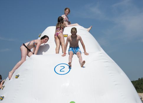HELLEVOETSLUIS,HOLLAND - JULY 08:Unidentified children having pun in the aqua splash park ,on July 08,2013 in Hellevoetsluisk, Holland.This water park is the only open water park in Holland