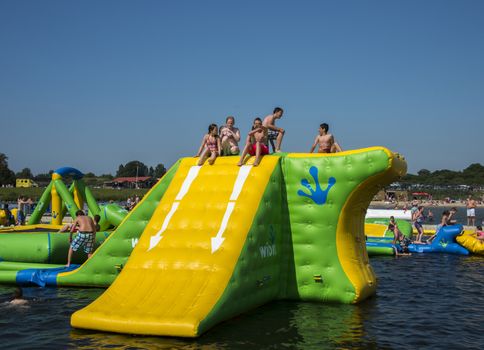 HELLEVOETSLUIS,HOLLAND - JULY 08:Unidentified children having pun in the aqua splash park ,on July 08,2013 in Hellevoetsluisk, Holland.This water park is the only open water park in Holland