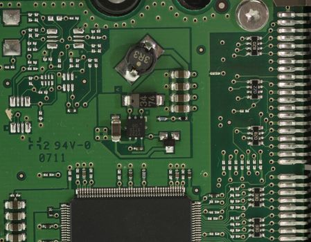 Green Electrical Circuit Board with microchips, conductors, and transistors