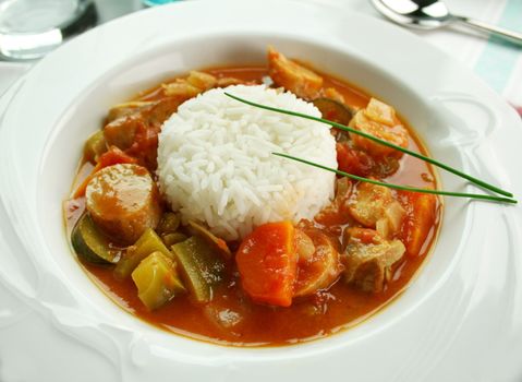 Delicious chicken gumbo with rice, sausage, peppers, onions, carrots and tomatoes.