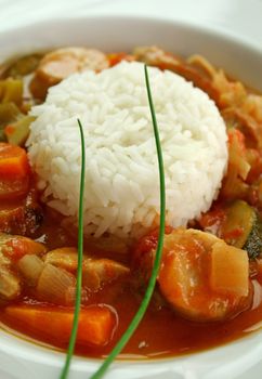 Delicious chicken gumbo with rice, sausage, peppers, onions, carrots and tomatoes.