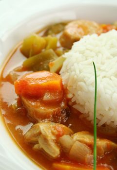 Delicious chicken gumbo with rice, sausage, peppers, onions, carrots and tomatoes.