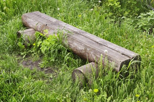 A bench made ������of log in the village street