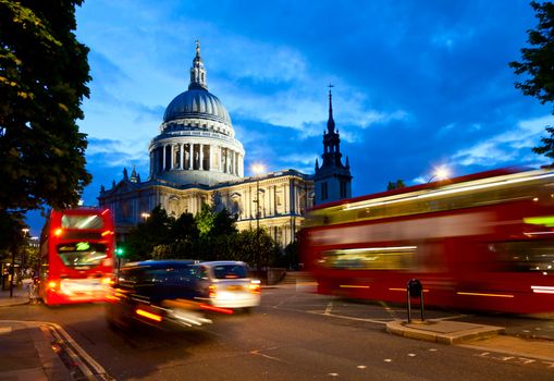 London cityscape with St Paul's Cathedral and moving Double Decker buses at night