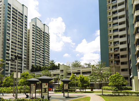 A new apartment neighborhood with carpark and playground.