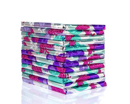 stack of presents in pink silver and green isolated on white background