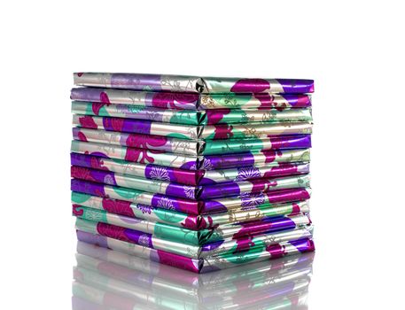 stack of presents in pink silver and green isolated on white background