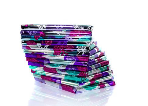 stack of presents in pink silver and green isolated on white background