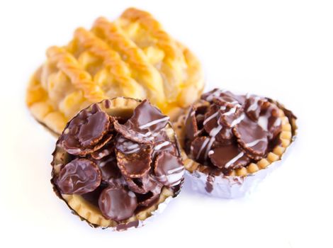 Set of tasty tartlets with chocolate isolated on white background