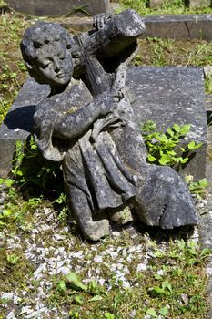 A fallen angel sculpture in Highgate Cemetery, London.